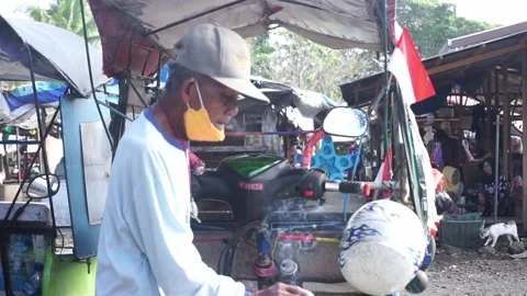 A motorized rickshaw driver is smoking while Stock Footage 208306551