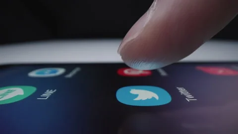 Motorized slow motion moving shot of clicking Twitter app icon Stock Footage 141094747