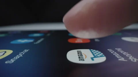 Motorized slow motion moving shot of clicking Amazon app icon Stock Footage 141231908