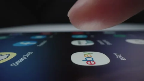 Motorized slow motion moving shot of clicking ebay app icon Stock Footage 141232955