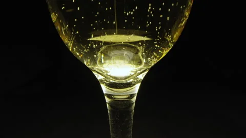 Motorized vertical rising macro rotating shot of glass of champagne Video stock 156792039
