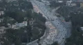 Motorway with Automobiles Houses Roofs Hollywood Los Angeles Car Traffic Highway HD Footage