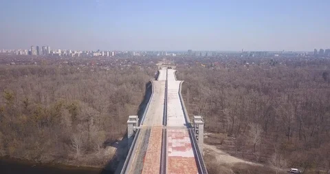 Motorway bridge under construction and passing over a forest and Stock Footage 127215752