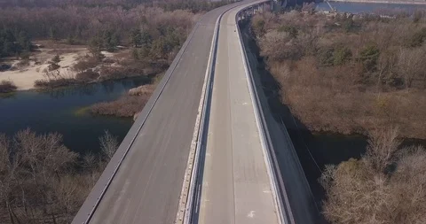 Motorway bridge under construction and passing over a forest Stock Footage 127215960