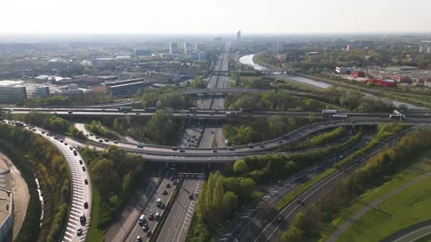 Motorway cloverleaf ramp ghent aerial view looping road bend canal barge Stock Footage 341750153