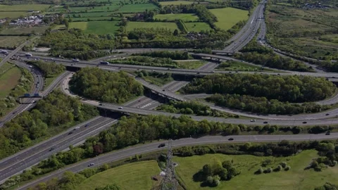 Motorway Interchange Connecting Multiple Roads in Green Landscape Stock Footage 334168225