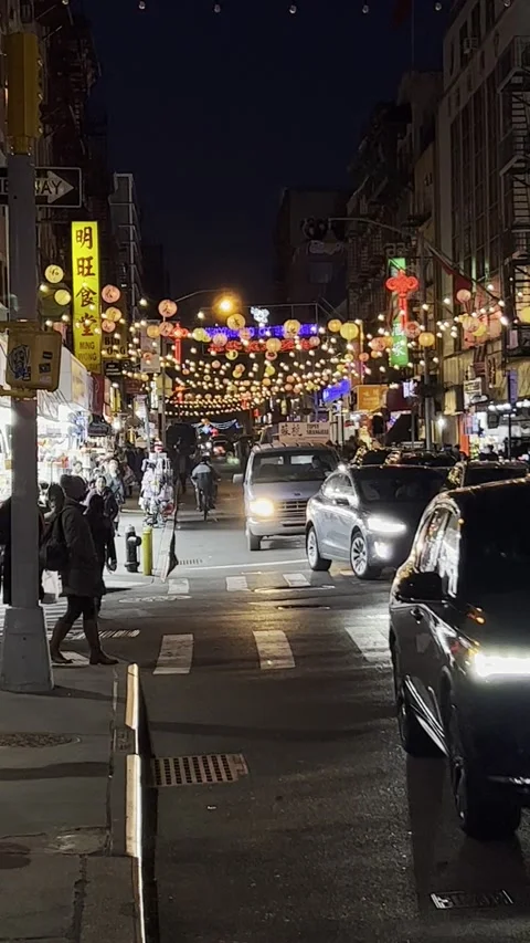 Mott Street Night Traffic Under Festive Lantern Canopy in Chinatown Stock Footage 328297748