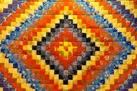 Mottled background in patchwork fabrics of different colors Stock Photos