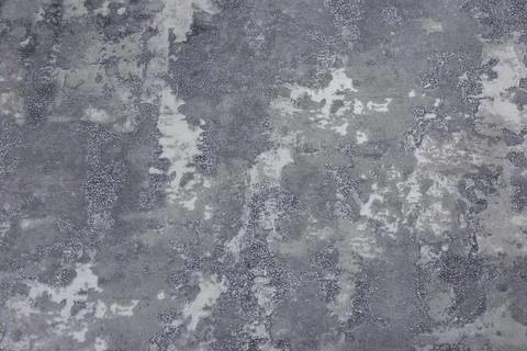 Mottled gray wall texture resembling aged concrete with soft tonal variation Stock Photos