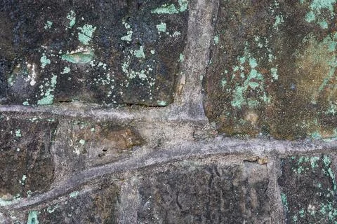 Mottled lines and oxidation marks on the ancient stone wall Stock Photos