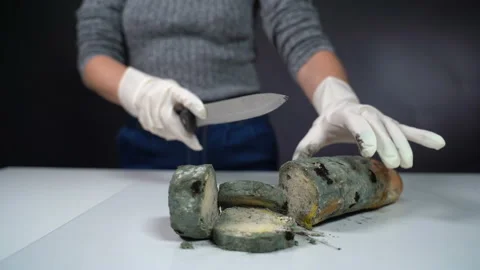 Mouldy bread is cut with a knife Stock Footage 119549304