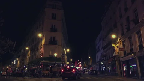 The Moulin Rouge by night in Paris, France. Stock Footage