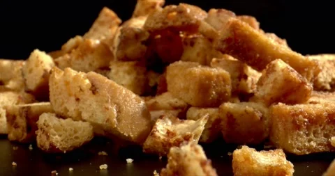 Mound of Crisps Snacks close-up on black background. Dry bread, in industrial Stock Footage 150033105