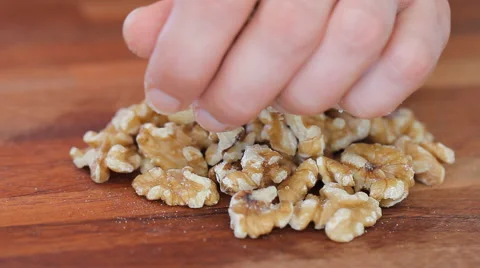 A mound of fresh walnuts being chopped on a cutting board Stock Footage 54800994