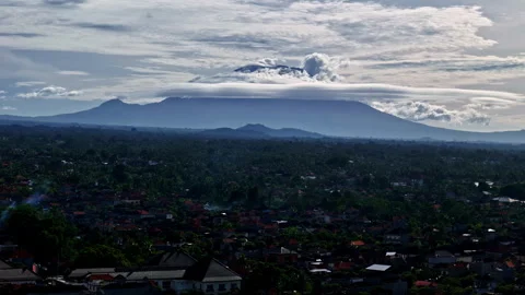 Mount Agung volcano with lenticular clouds over Ubud in Bali, Indonesia in Stock Footage 336778240