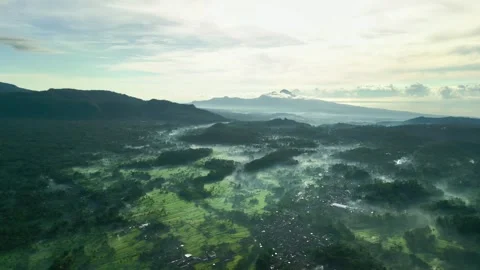 Mount Agung Volcano over Misty Rice Fields Aerial View Stock Footage 345374749