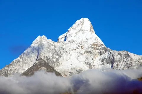 Mount Ama Dablam within clouds and blue sky Stock Photos