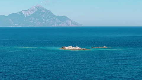 Mount Athos and Small Islet With Greek National Flag, Drone Aerial View Stock Footage 346263030