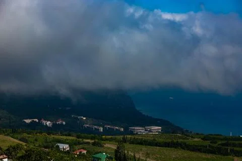 Mount Ayu Dag with clouds on the background of the Black Sea in the early mor Stock Photos
