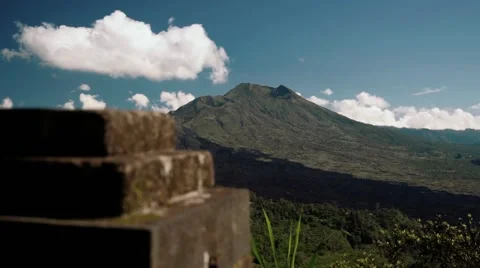 Mount Batur volcano view up close from behind a stone wall Stock Footage 64154820