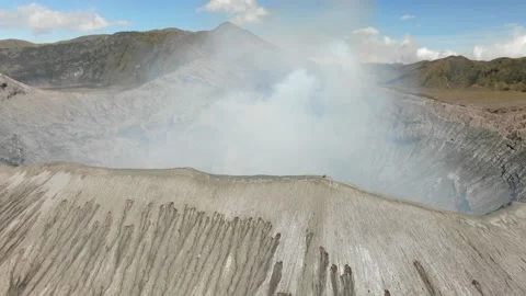 Mount Bromo is smoky active volcano with crater Stock Footage 160473968