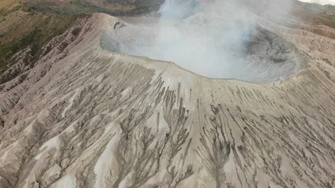Mount Bromo is smoky active volcano with crater Stock Footage 160474097