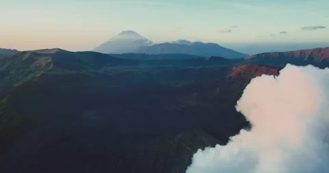 Mount Bromo Volcano Emitting Smoke at Sunrise – Indonesia Aerial Stock Footage 329259699