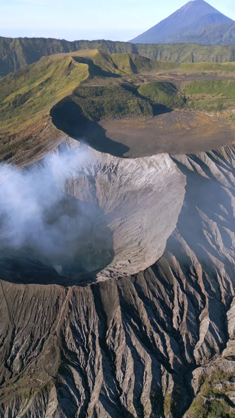 Mount Bromo volcano with steaming crater and Mount Semeru in the background 스톡 동영상 337568236