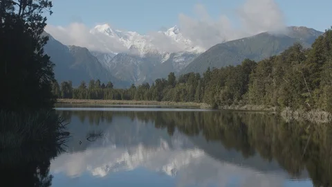 Mount. Cook and Mount. Tasman from Lake Matheson, New Zealand Stock Footage 90769692