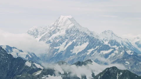 Mount Cook mid shot aerial tracking with foreground clouds Stock Footage