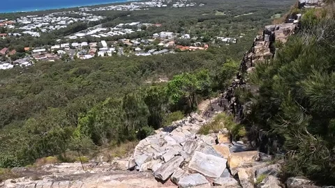 Mount Coolum Summit Trail: steep climb with rock steps and coastal views of.. Stock Footage 295241206