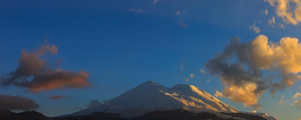 Mount Elbrus during sunset in the rays of the sun. Panoramic view of the moun Stock Photos
