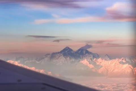 Mount Everest and mountain range during dusk seen from flight. Stock Photos
