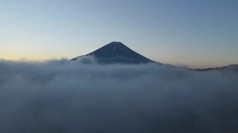 Mount Fuji Emerging Above a Sea of Clouds During Slow Drone Ascent Stock Footage 339630670