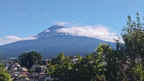 Mount Fuji Emerging from Clouds on a Clear Morning in Japan Stock Footage 346114595