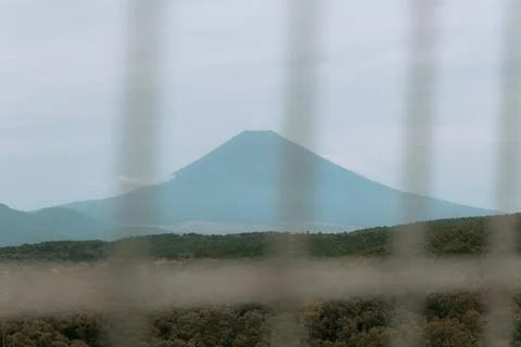 Mount Fuji seen through vertical suspension cables of the Mishima Skywalk bridge Stock Photos