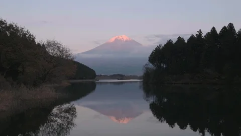 Mount Fuji turning red afetr sunset from lake Tanuki, Shizuoka Prefecture, Japan Stock Footage 99090641