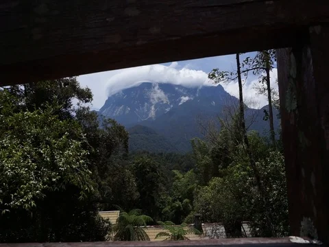 Mount Kinabalu with clouds surrounding the summit of the mountain. Stock Footage 94199863