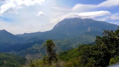 Mount Kinabalu time lapse with clouds against blue sky. Stock Footage 116861623