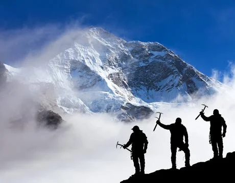 Mount Makalu with clouds and silhouette of three hikers Stock Photos