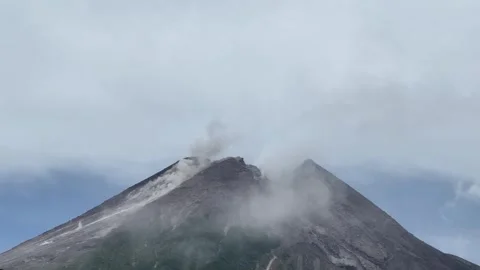 Mount Merapi erupting at sunrise 스톡 동영상 338014360