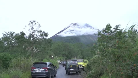 Mount Merapi erupting at sunrise seen from Kaliadem Stock-Footage 332532374