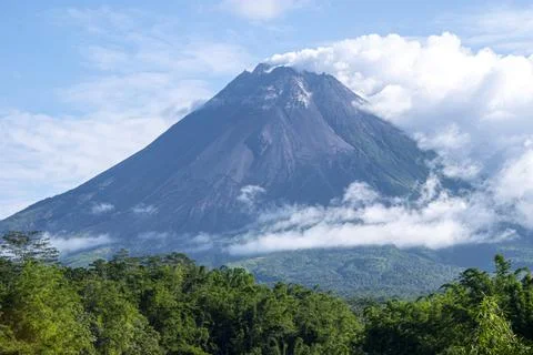 Mount Merapi peak with smoke under the blue sky Stock Photos