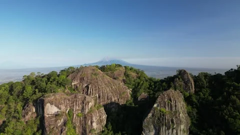 Mount Merapi seen afar from the peak of the Nglanggeran Ancient Volcano Stockbeeldmateriaal 347535107
