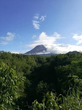 Mount Merapi seen in the distance against the blue sky Stock Photos