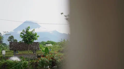 Mount Merapi is seen from a distance wit... | Stock Video | Pond5