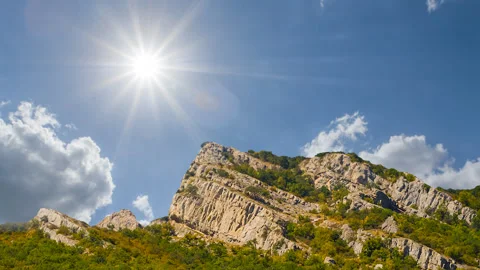 Mount peak among green forest under sparkle sun Stock Footage 315515237