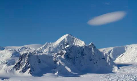 Mount Shackleton and clouds above it in a blue bright sky on the Antarctic Pe Stock Photos