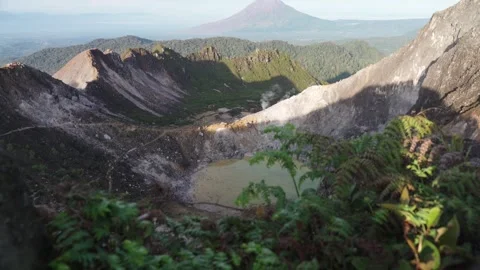 Mount Sibayak Crater Viewed Between Rocks and Ferns Stock Footage 348601098