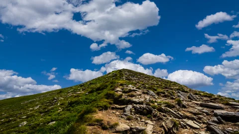 Mount top on a blue cloudy sky background Stock-Footage 335784710